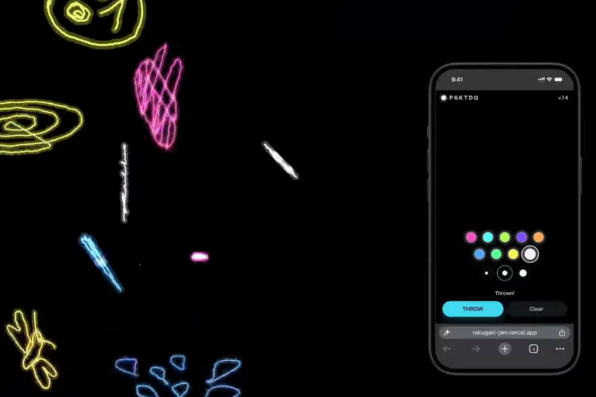 Bright neon doodles scattered across a dark wall screen, with a phone beside it drawing another one